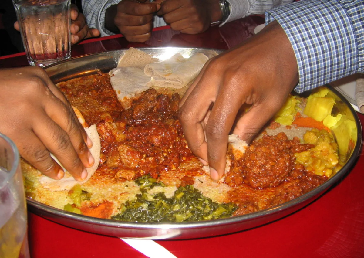 Guests sharing traditional Ethiopian food at Tibeb